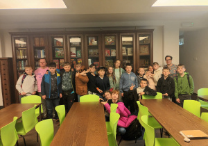 zdjęcie klasy na tle księgozbiorów